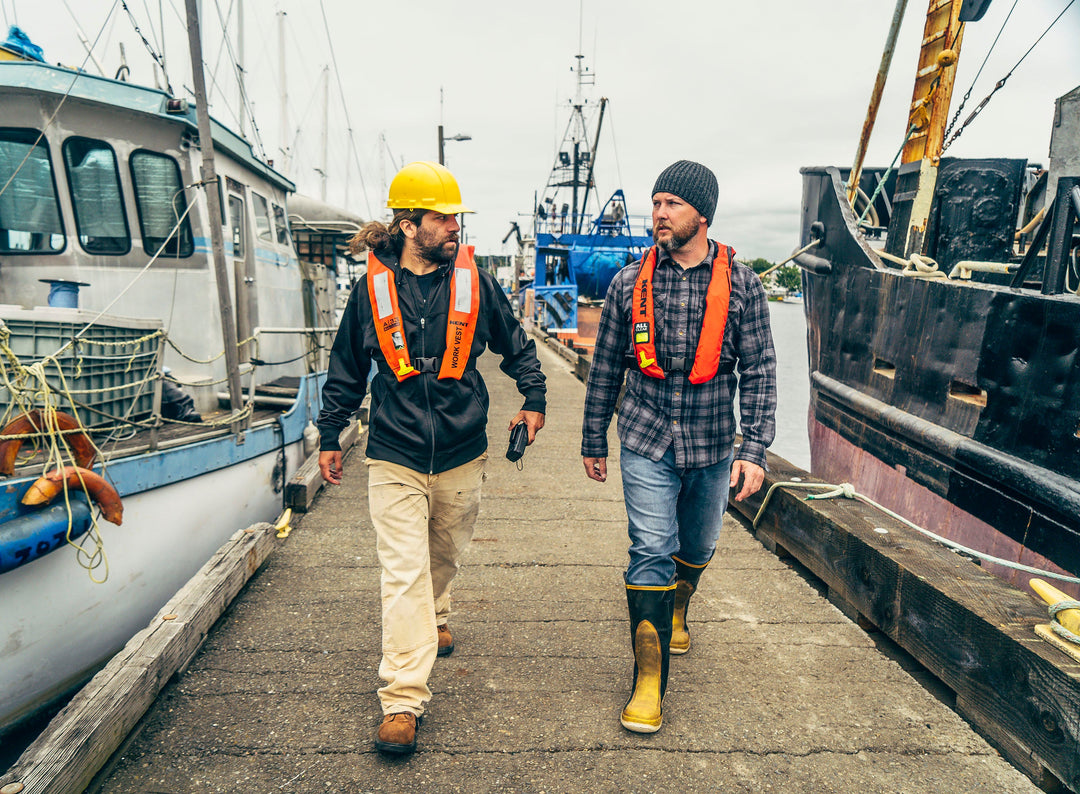 Two workers wearing Hi-Vis Inflatable Life Vests from Kent Safety Products walking down a pier.