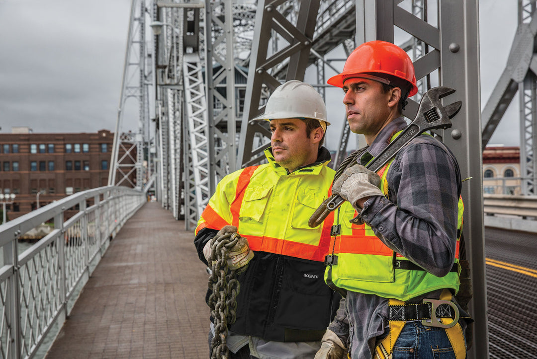 Two workers on a bridge wearing Hi-Vis Flotation Jackets from Kent Safety Products.