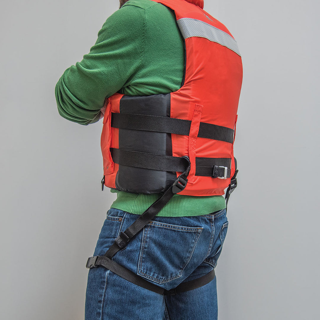 Person in orange Universal Thigh Straps over a green sweater, seen from the side.