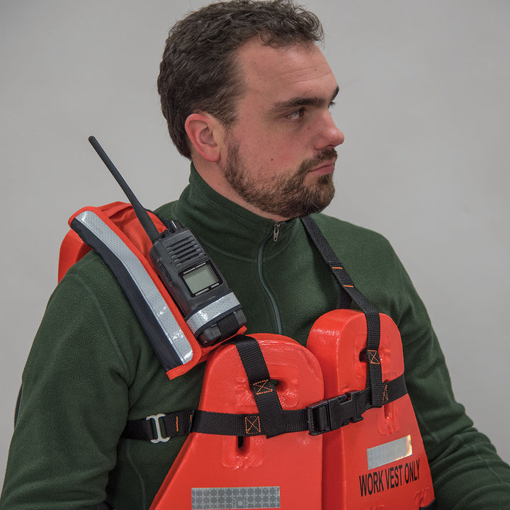 Man in a bright orange life vest with SOLAS-grade material and a Radio Pocket.